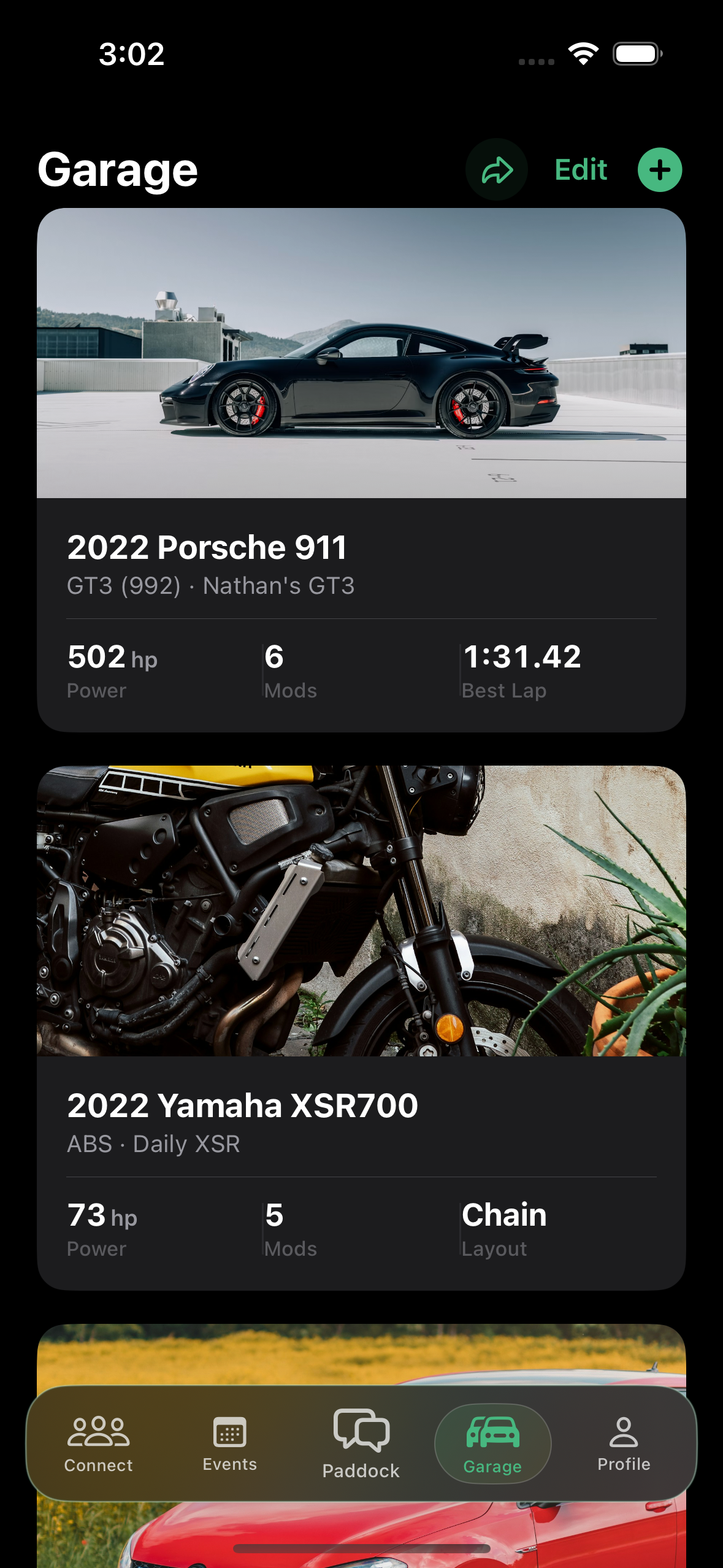Paddock garage showing a Porsche 911 and Yamaha motorcycle